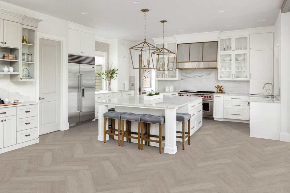 grey toned herringbone luxury vinyl in all white modern kitchen